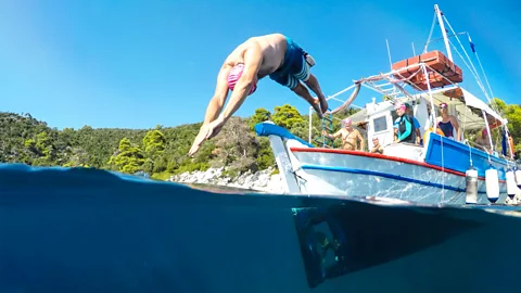 Someone diving head first off a boat into water (Credit: Andrew Cole)