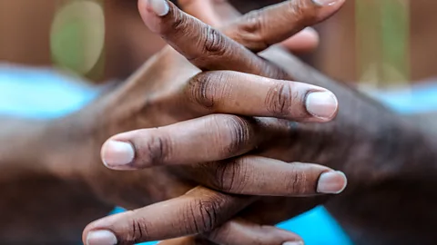 Two hands clasped together with healthy nails (Credit: Getty Images)