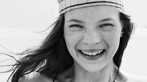 A black and white image of Kate Moss at 16-years-old, smiling at the camera (Credit: Estate of Corinne Day/ Bridgeman Images)