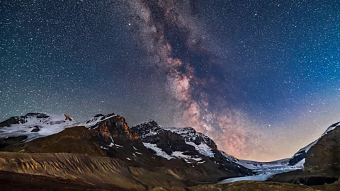 Mountains with a display of stars and the Milky Way in the night sky (Credit: Alamy)