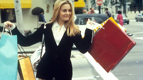 A bright yellow illustration of characters from Clueless, including Cher in her iconic tartan outfit and an image of Amy Heckerling at the forefront (Credit: Emmanuel Lafont)