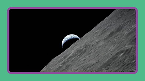 The Earth rising above the surface of the Moon.