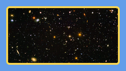 A sea of galaxies floating in space.