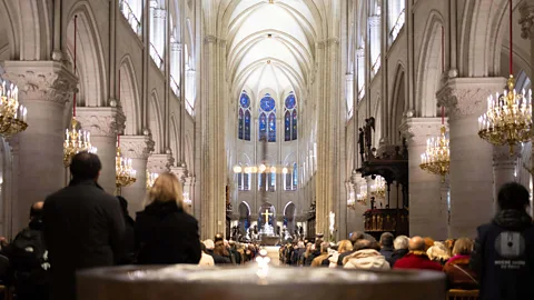 A view of the inside of the Cathedral of Notre-Dame de Paris with people seated inside the nave during a mass (Credit: Getty Images)