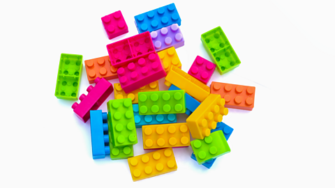 Pink, yellow and green interlocking toy bricks