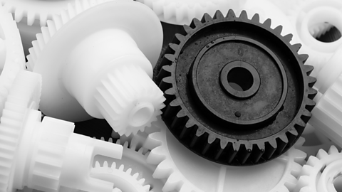 Black and white nylon gears in a pile