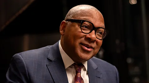 American musician Wynton Marsalis wears a dark blue suit and thick black glasses (Credit: Natassja Ebert)