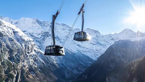 Two cable gondolas moving past each other in the Swiss Alps (Credit: Schilthorn Cableway Ltd)