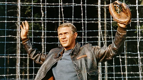 Steve McQueen holding his hands up in The Great Escape (Credit: Alamy)