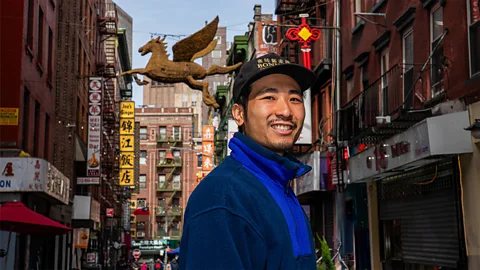 Ernesto Roman posing on a street in New York City's Chinatown (Credit: Ernesto Roman)