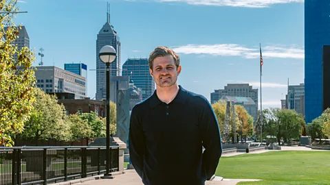 Marcus Ericsson stood in Indianapolis with a park and skyscraper behind him (Credit: Andretti Global/ Alex Frick)