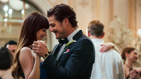 A still of Dakota Johnson and Pedro Pascal dancing together in The Materialists (Credit: A24)