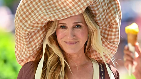 Sarah Jessica Parker wearing a massive gingham bonent in And Just Like That... season three (Credit: Getty Images)