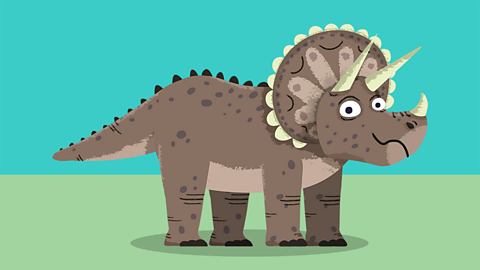 Image of a triceratops which is grey and has white horns. 