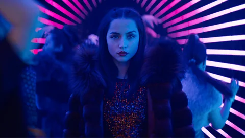 Ana de Armas in a neon-lit nightclub corridor in Ballerina (Credit: Lionsgate)