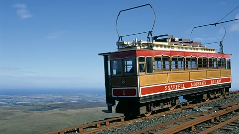 Snaefell Mountain Railway on the Isle of Man with a view of the land and ocean behind (Credit: Alamy)