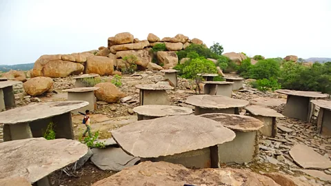 The stone chambers with rock formations in the background at Hire Benkal (Credit: Bansari Kamdar)