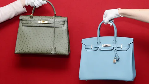 A composite of different coloured handbags against a red background (Credit: Serenity Strull/ Courtesy of Sotheby's)