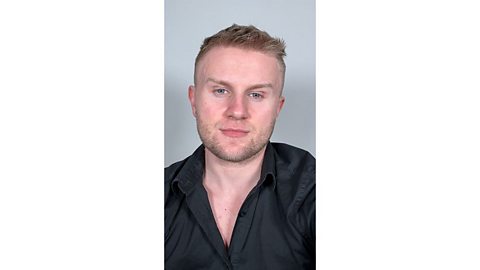 Man with a clean face dressed in a black shirt