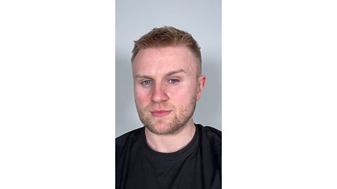 Man with a clean face wearing a black t shirt