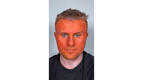 Man with an orange painted face