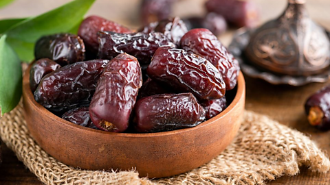 Dried dates in a bowl.