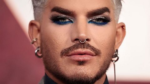 Close of singer Adam Lambert wearing full make, including bold and sparkly eyes, with a neat moustache and seperate beard