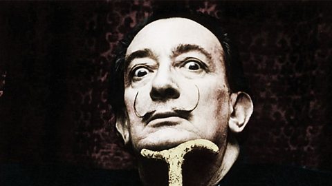Close of Salvador Dali whose thin but long moustache is curled upwards towards his eyes