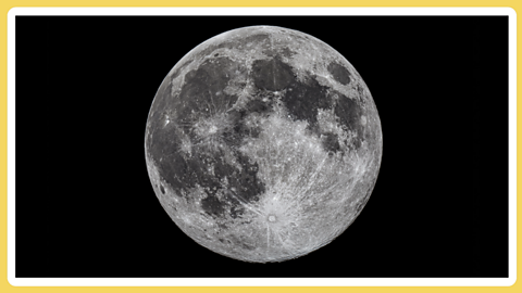 The mooh in the centre of a black background