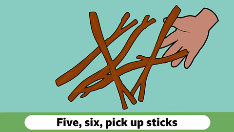 A cartoon hand picking up some sticks, with the words five six pick up sticks below