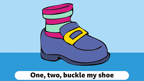 A cartoon shoe with stripy sock and a yellow buckle. The words, one, two, buckle my shoe appear below