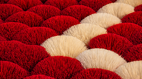 A photo of colourful incense sticks.