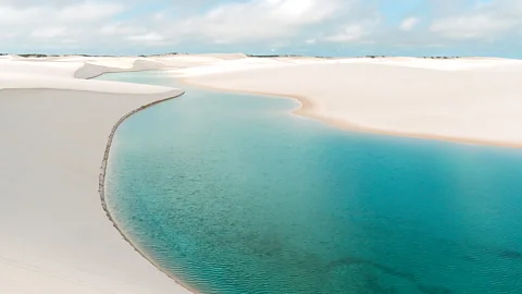 Blue lagoon and rolling sand dunes in Lençóis Maranhenses National Park, Brazil (Credit: Carla Vianna)