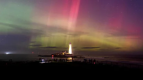The Northern Lights over a lighthouse (Credit: Wil Photography)