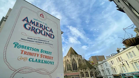 A sign in front of a church and houses which reads "America Ground" (Credit: Debbie Ward)