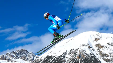 An Alpine skier does a jump at the 2026 Milan-Cortina Winter Olympics (Credit: Getty Images)
