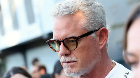 A man with ALS being pushed in a wheelchair (Credit: Alamy)