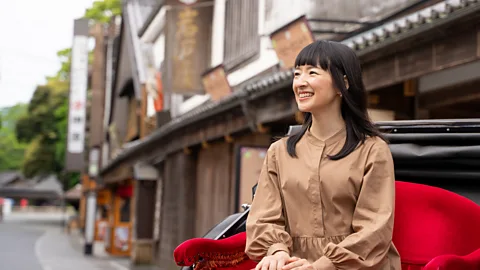 Marie Kondo sits near a street in Japan (Credit: KonMari)