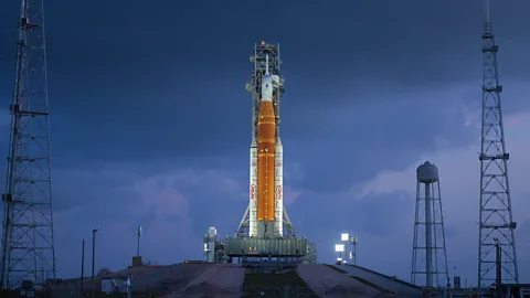 The Moon visible behind the Orion spacecraft atop the SLS rocket system at the launchpad (Credit: Nasa/ Jim Ross)