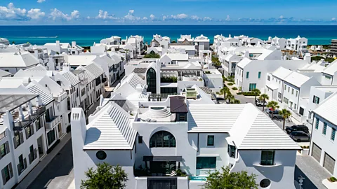 An aerial shot of a city where all the buildings are white and there is a bright blue sea in the distance (Credit: Moon Creek Studios, courtesy of Alys Beach, FL)