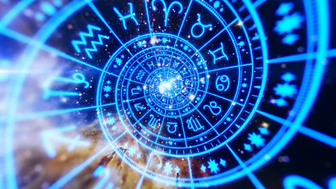 Blue toned zodiac wheel in concentric circles over a starry cosmic background (Credit: Getty Images)