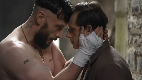 Richard Gadd, with his hands wrapped in bandages, holds Jamie Bell's face with their heads pressed together in a still taken from Half Man (Credit: BBC)