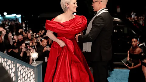 Meryl Streep in a red gown next to Stanley Tucci in The Devil Wears Prada 2 (Credit: 20th Century Fox)