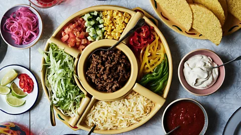 Aerial view of taco shells and toppings laid out on a table for a family meal (Credit: Taco!/ Lars Petter Pettersen)