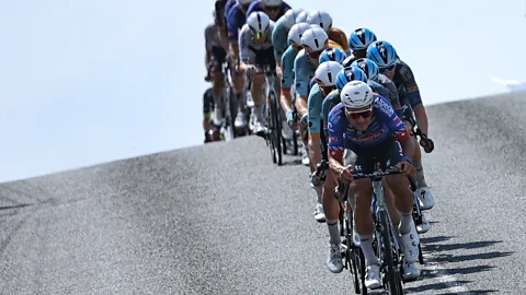 A line of Tour de France riders cresting over a hill (Credit: Getty Images)