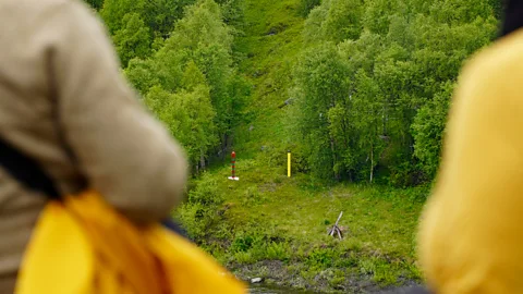 A forest path with two post markers being watched by two guards (Credit: Kirkenes Tours)