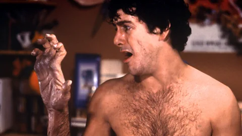 David Naughton looks at his hand as he begins to transform into a werewolf in An American Werewolf in London (Credit: Getty Images)