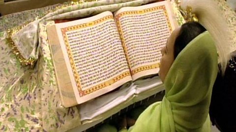 A young Sikh explains some key features of Sikh beliefs while looking around a gurdwara