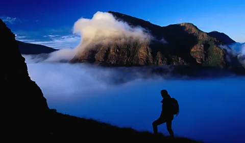A hiker watches dawn break over Buachaille Etive MÃ²r in Glen Coe. (Gareth McCormack/LPI)