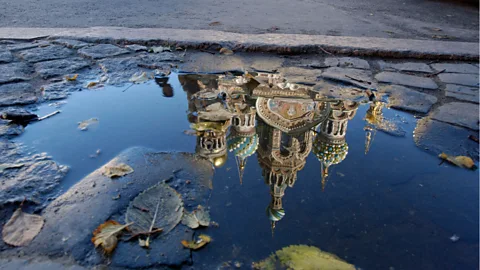 The Church of the Saviour on the Spilled Blood, seen reflected in a puddle in St Petersburg. (Jeff Overs/BBC)